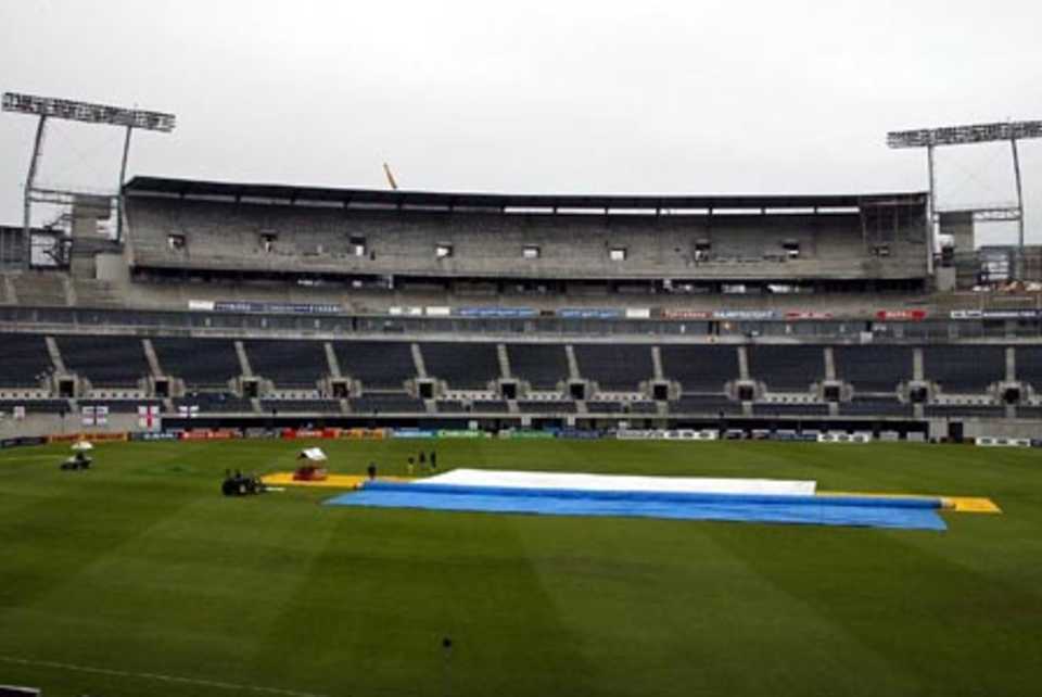 The new West Stand in the background with the covers are on the pitch as rain delays the start of play on day two. 1st Test: New Zealand v England at Christchurch, 13-17 Mar 2002