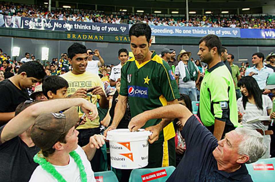 Umar Gul collects money from spectators for the Haiti earthquake victims
