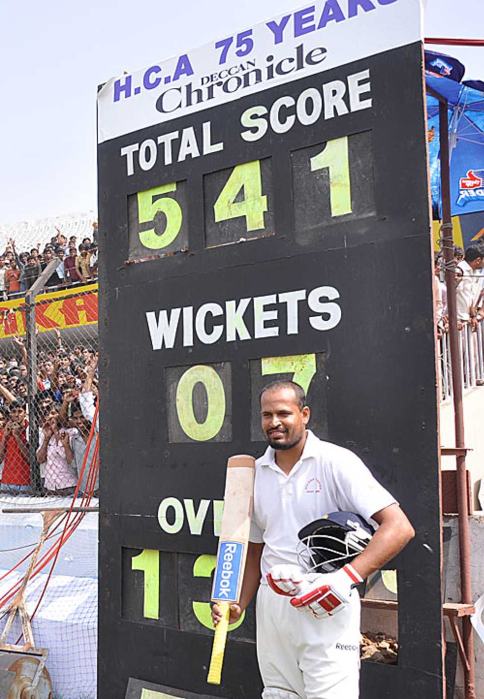Yusuf Pathan poses near the scoreboard after West Zone's mammoth chase