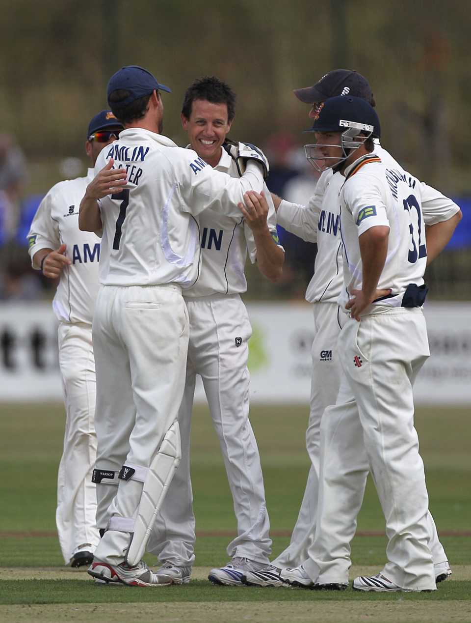 Bryce McGain is congratulated by his Essex team-mates after collecting four wickets