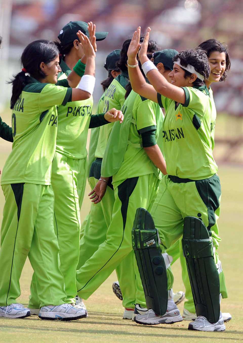 The Pakistan players celebrate on their way to an easy opening victory