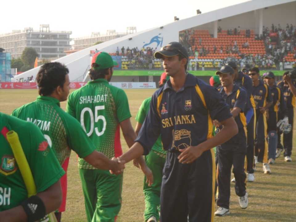 The Bangladesh and Sri Lanka cricket teams shake hands at the end of their match
