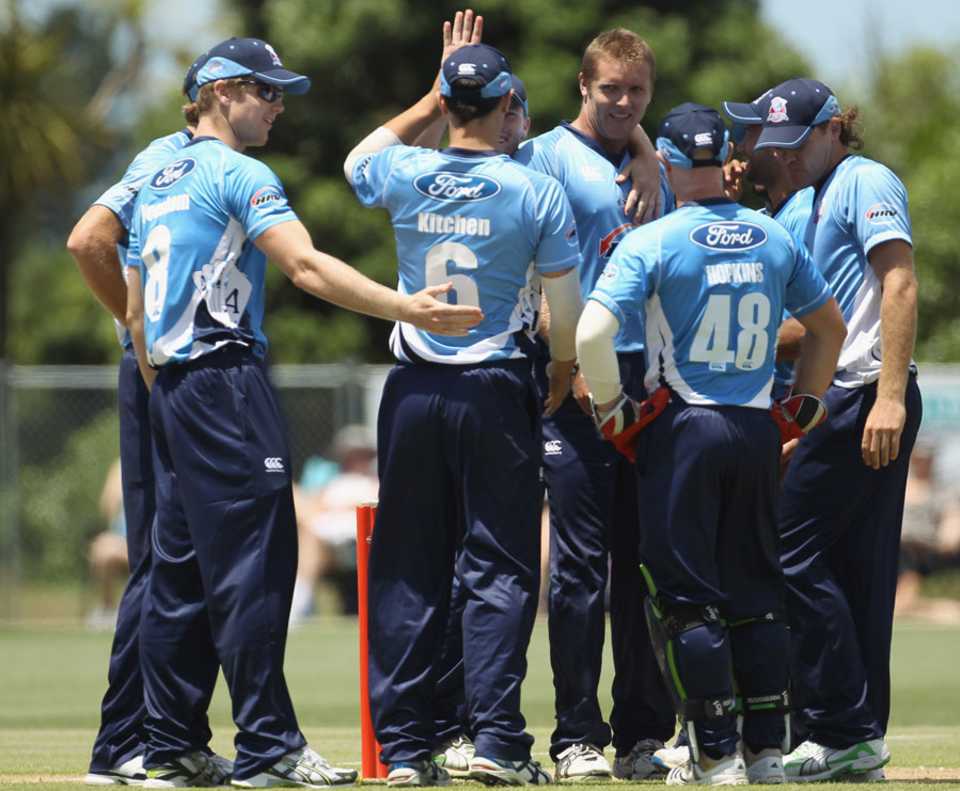 Michael Bates is congratulated by his team-mates after dismissing Shahid Afridi