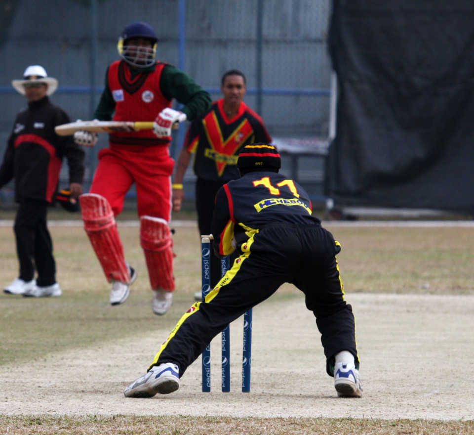 Papua New Guinea wicketkeeper Jack Vare completes a run out