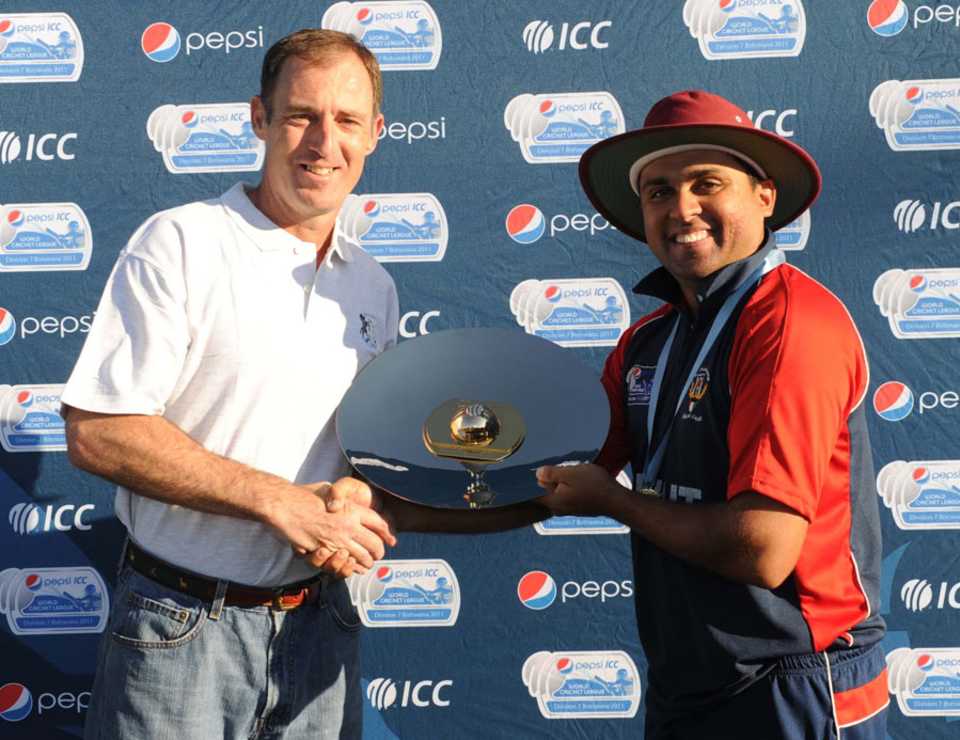 ICC and Bermuda Cricket director Neil Speight presents the WCL Division 7 trophy to Hisham Mirza