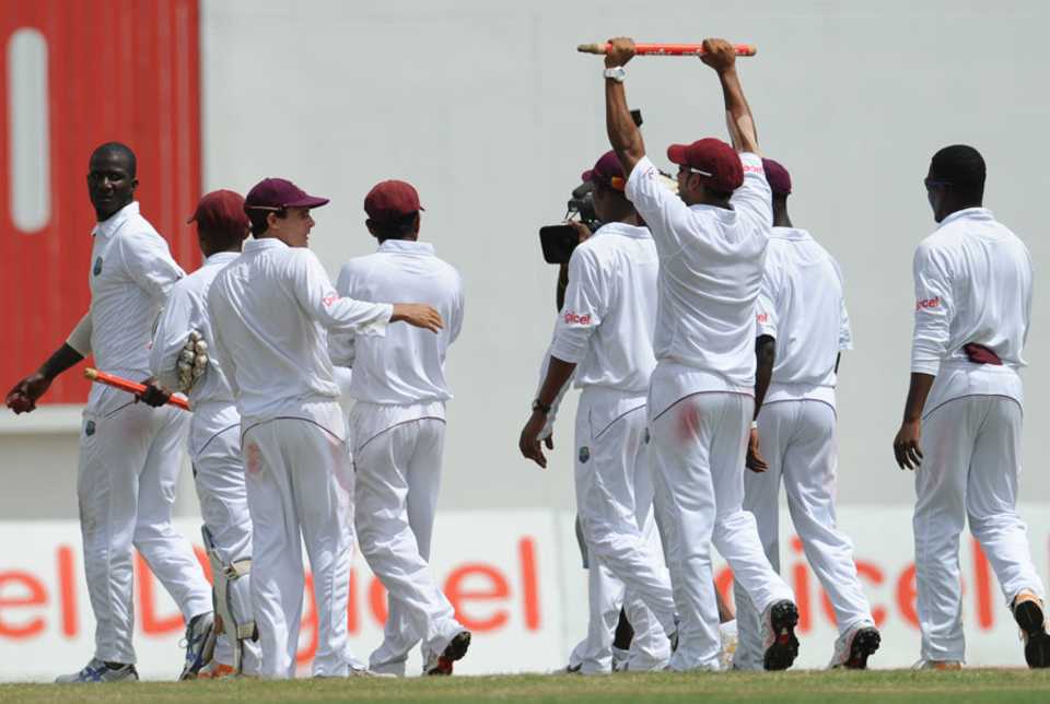 Darren Sammy leads his team off the field after their win 