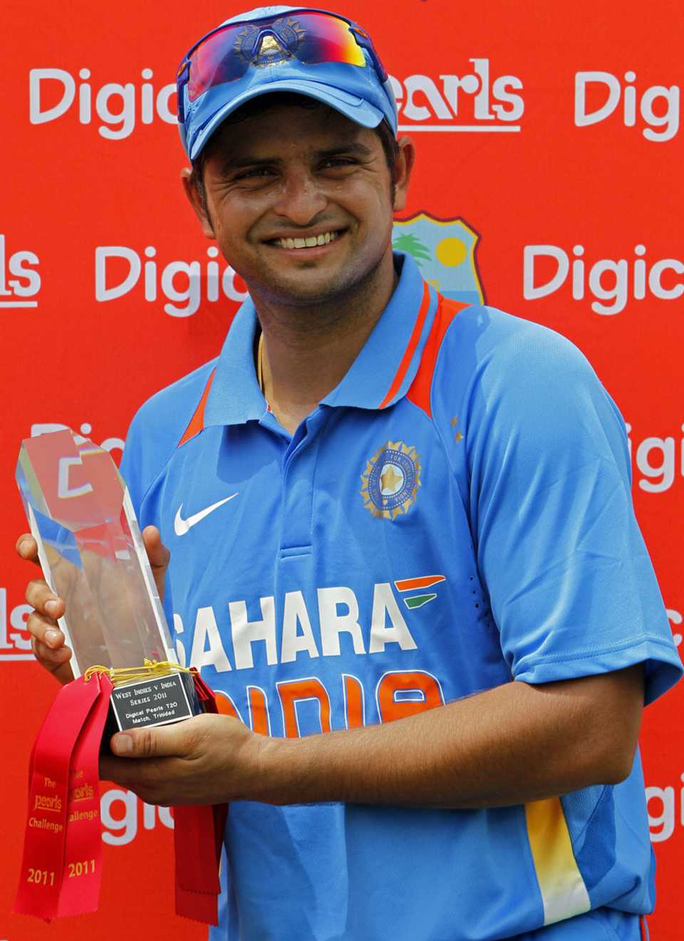 Suresh Raina poses with the winners' trophy