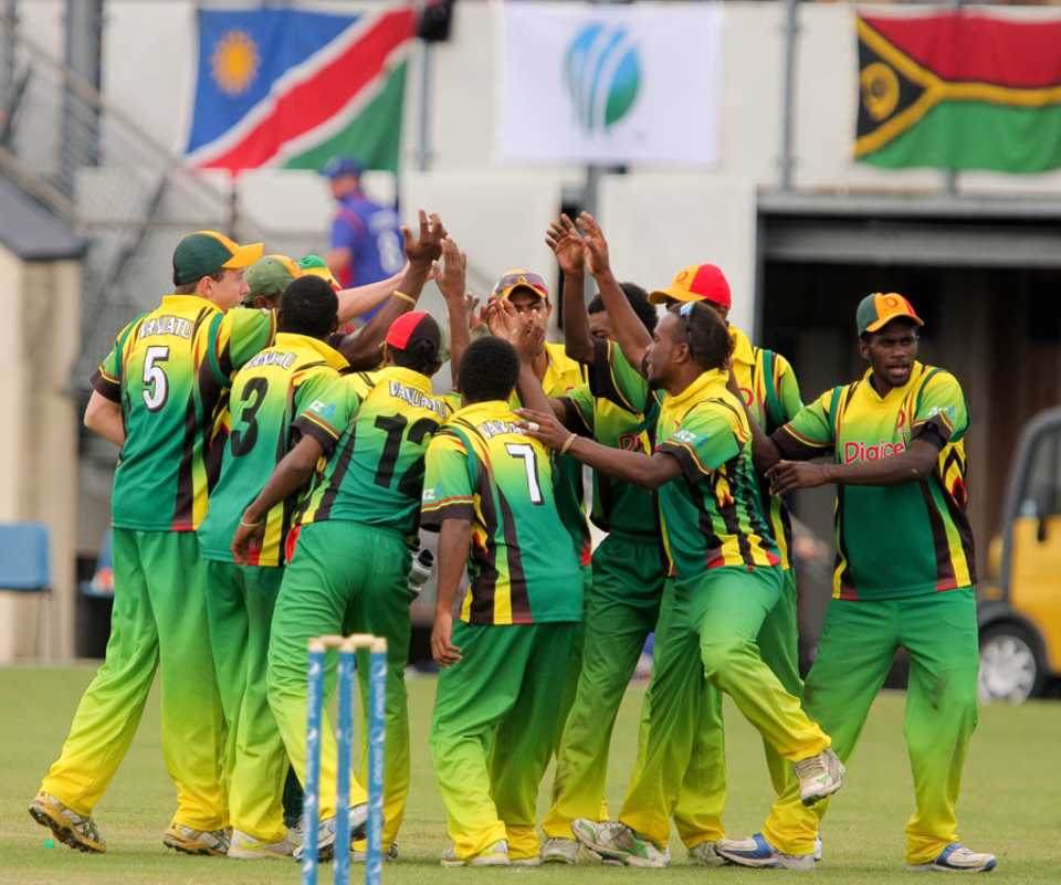 The Vanuatu fielders celebrate the fall of a wicket