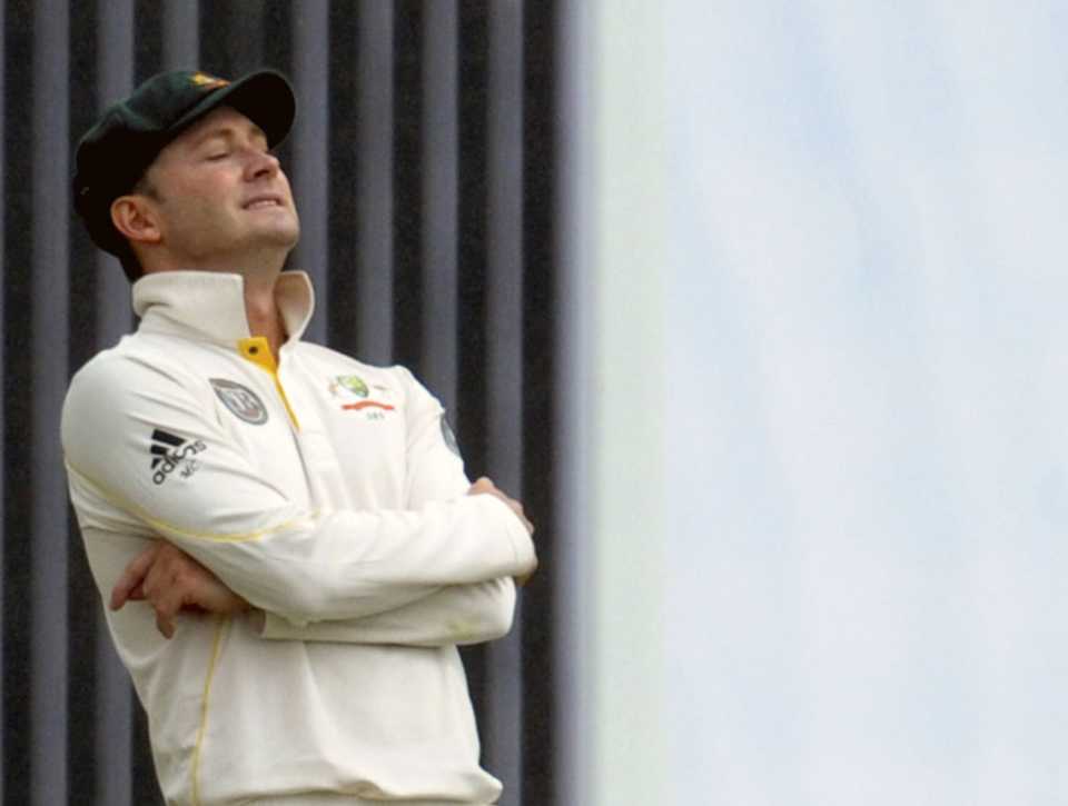 Michael Clarke reacts as the rains come down