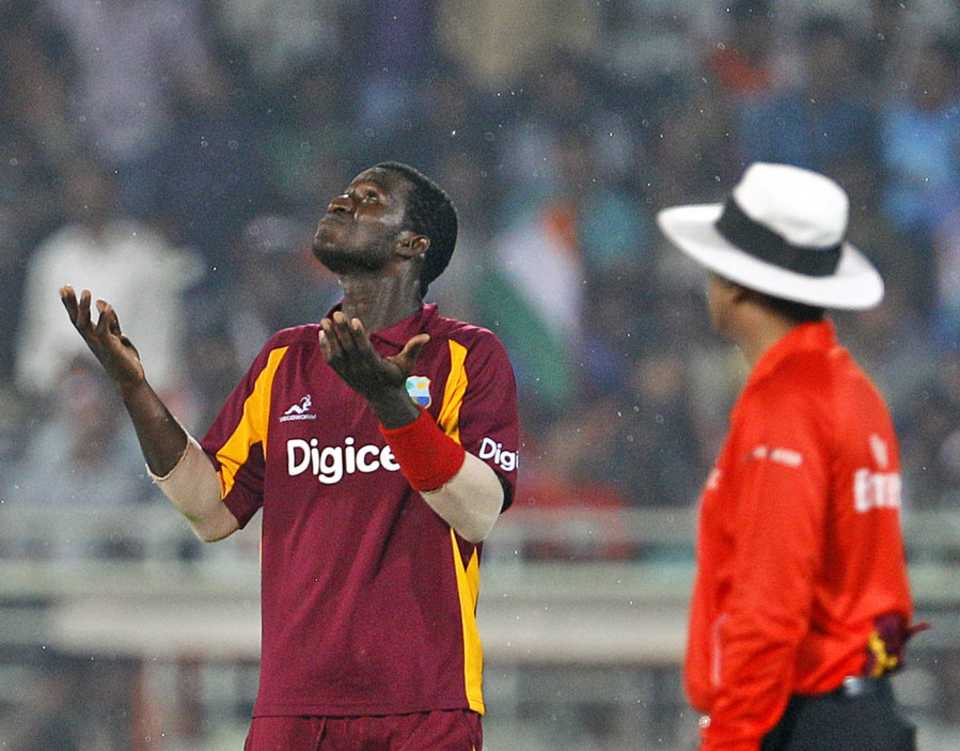 Darren Sammy looks up to see if the rain has stopped