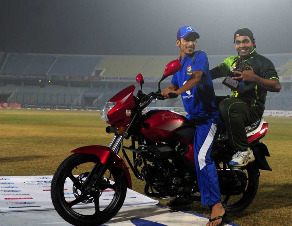 Nasir Hossain gives Umar Akmal a ride on the bike he won as Bangladesh's best player