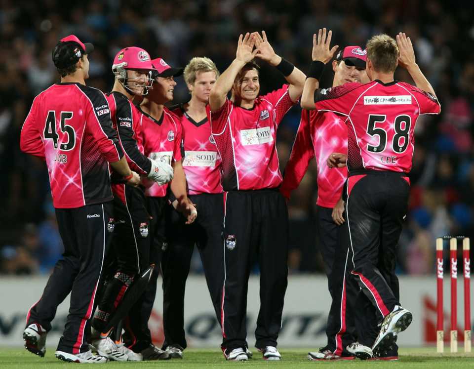 Nathan McCullum is congratulated on one of his two wickets 