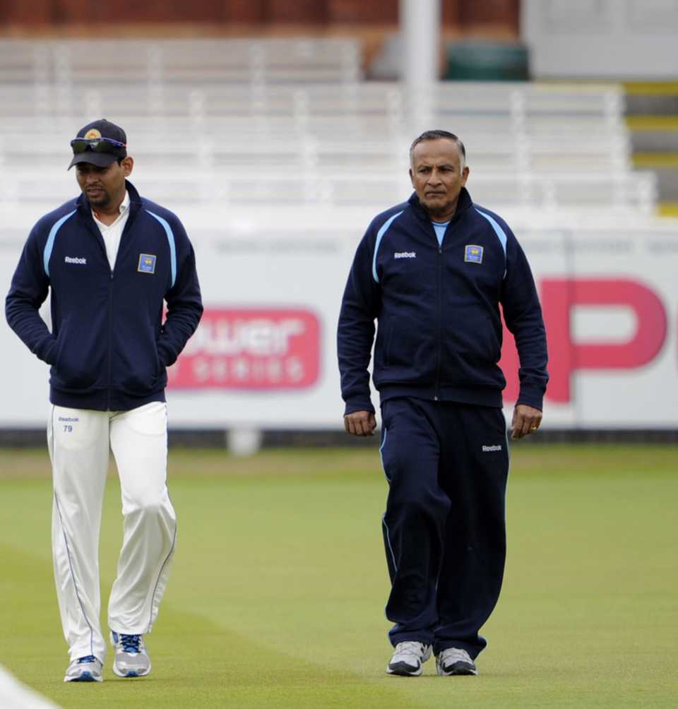 Tillakaratne Dilshan and team manager Anura Tennekoon walk around the ground during practice