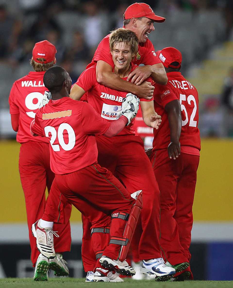 Zimbabwe mob Kyle Jarvis after getting a wicket