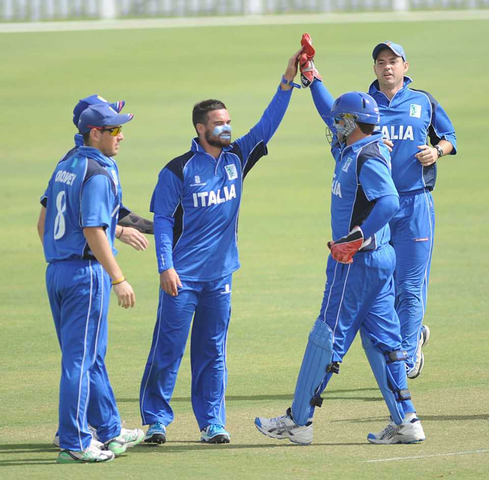 Italy celebrate a wicket against Oman