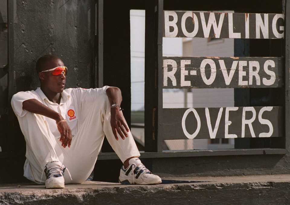 Vasbert Drakes takes a break by the scoreboard, West Indies Board XI v Australians, 3rd day, St Kitts, April 17, 1995