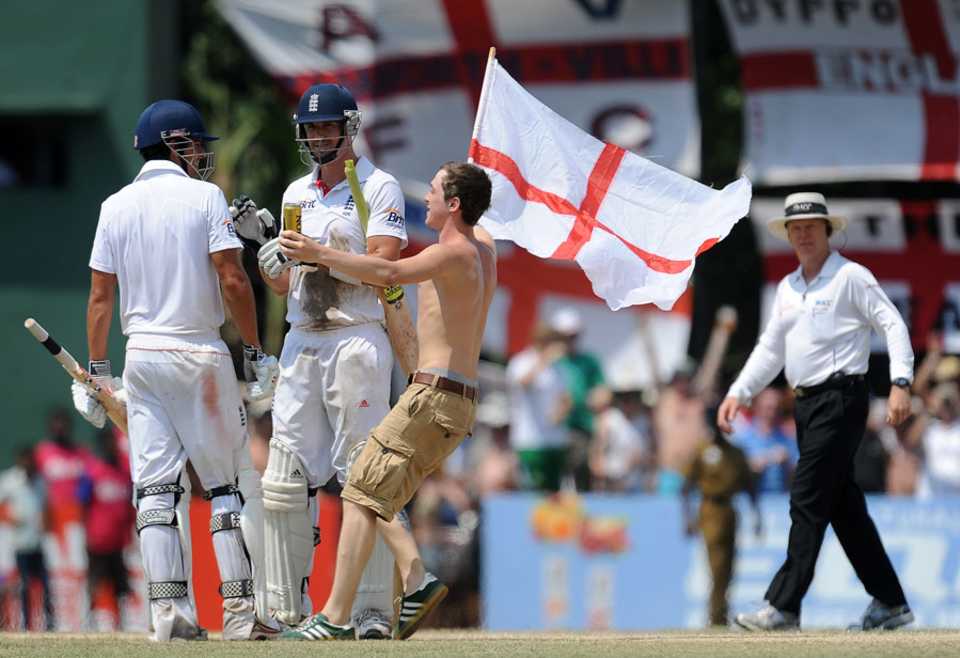 An England fan joins Kevin Pietersen and Alastair Cook in the middle