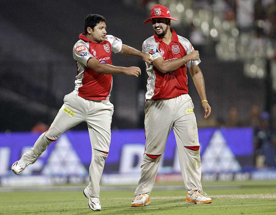Piyush Chawla and Harmeet Singh celebrate a wicket