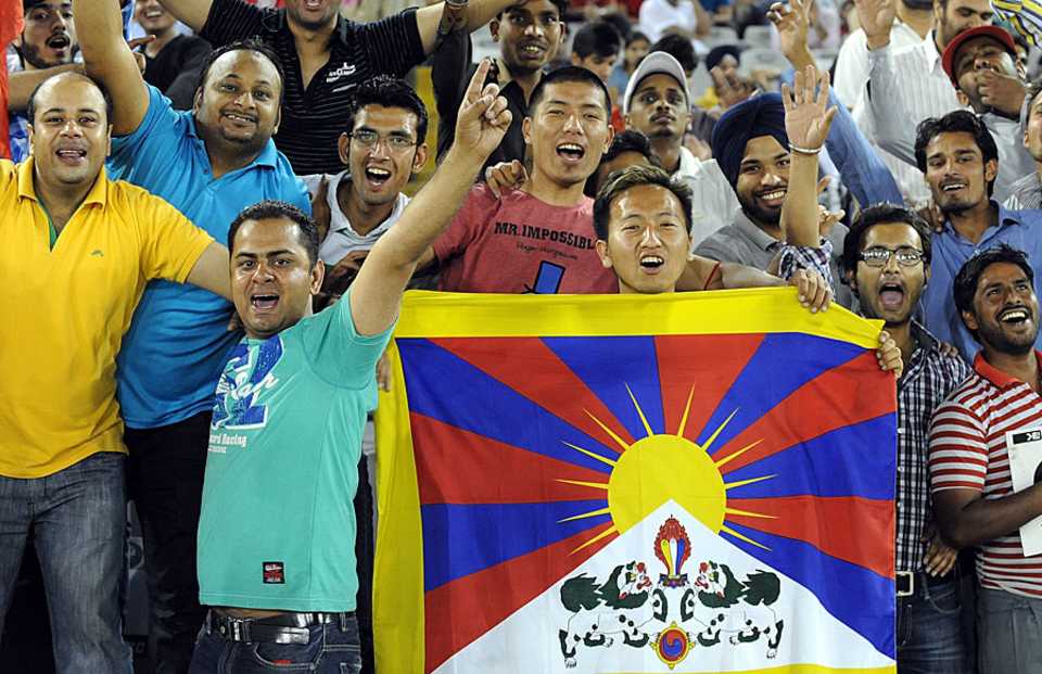 Tibetan fans have some fun at an IPL game