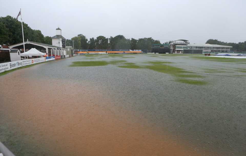 Rain falls on the flooded outfield