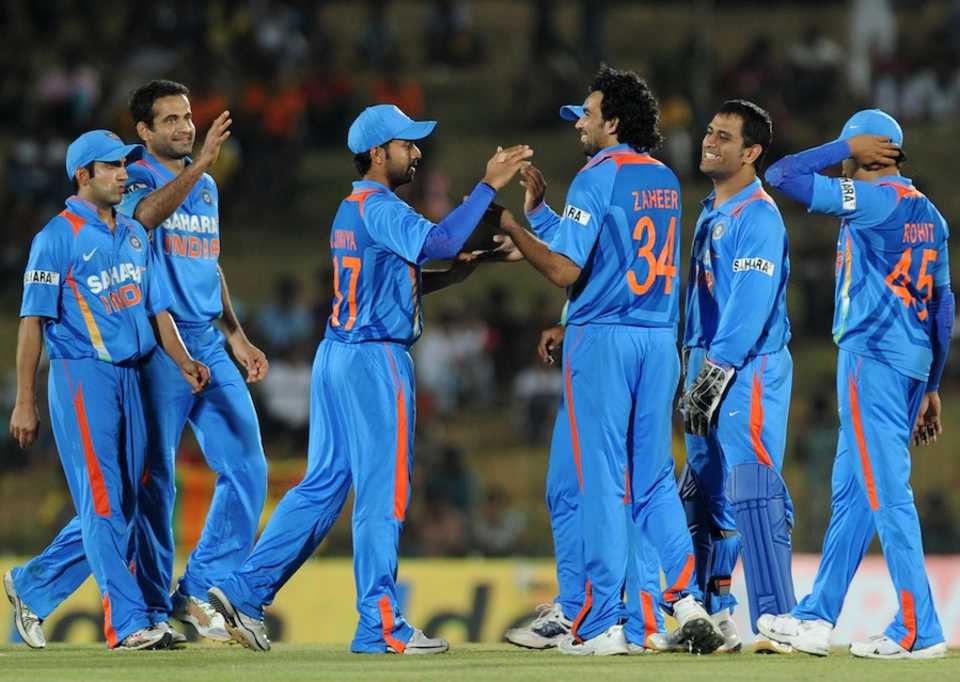 Indian players celebrate a fall of wicket