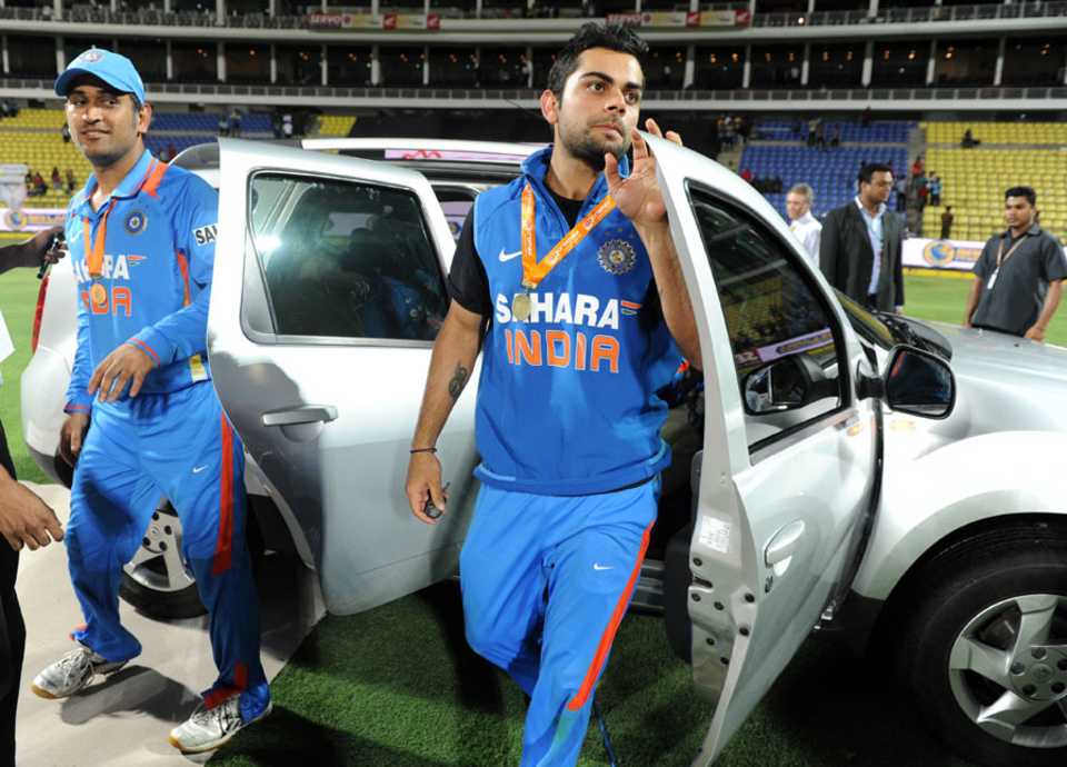 Virat Kohli and MS Dhoni exit the prize jeep after winning the series