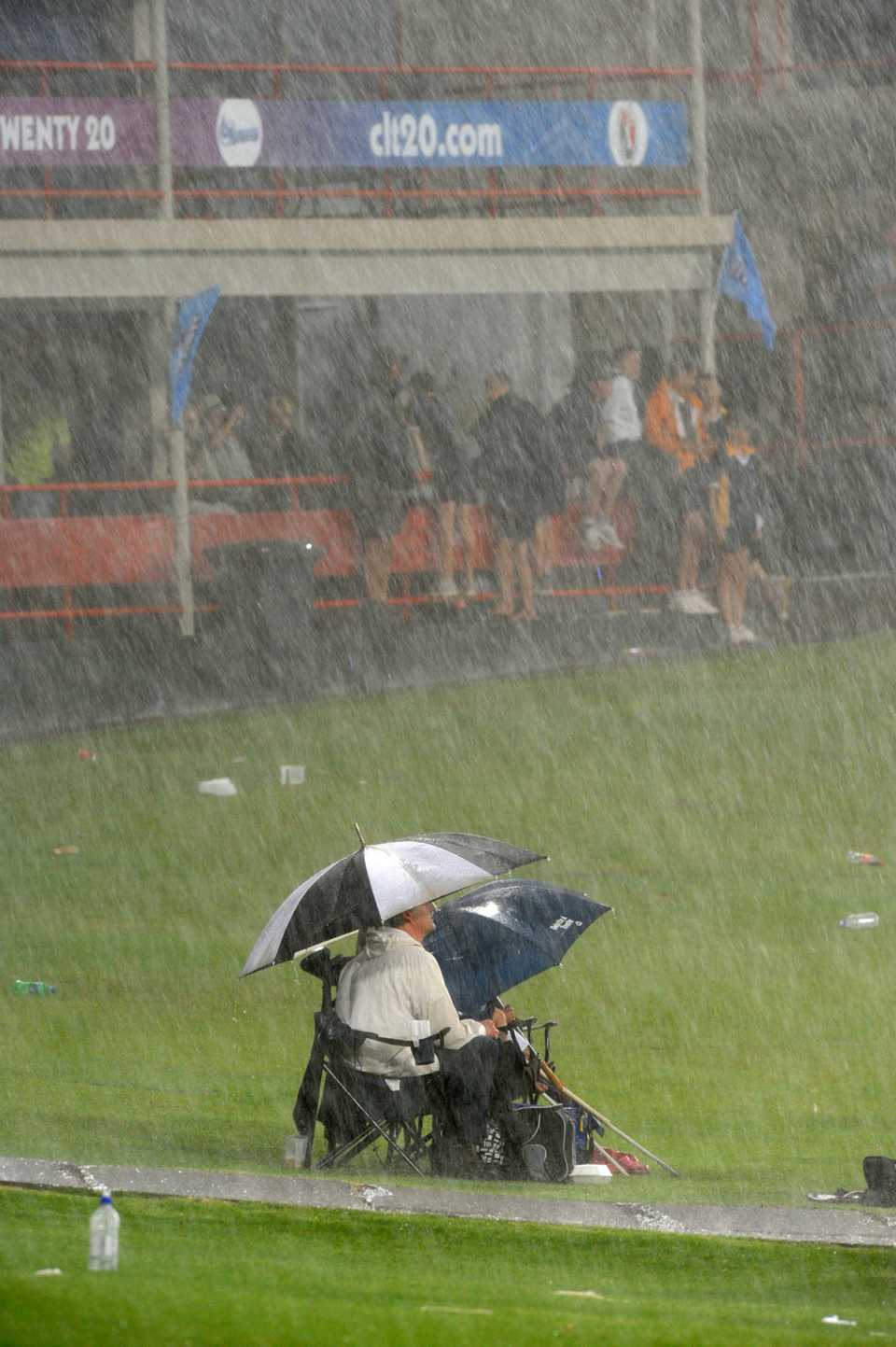 Fans sit out the rain
