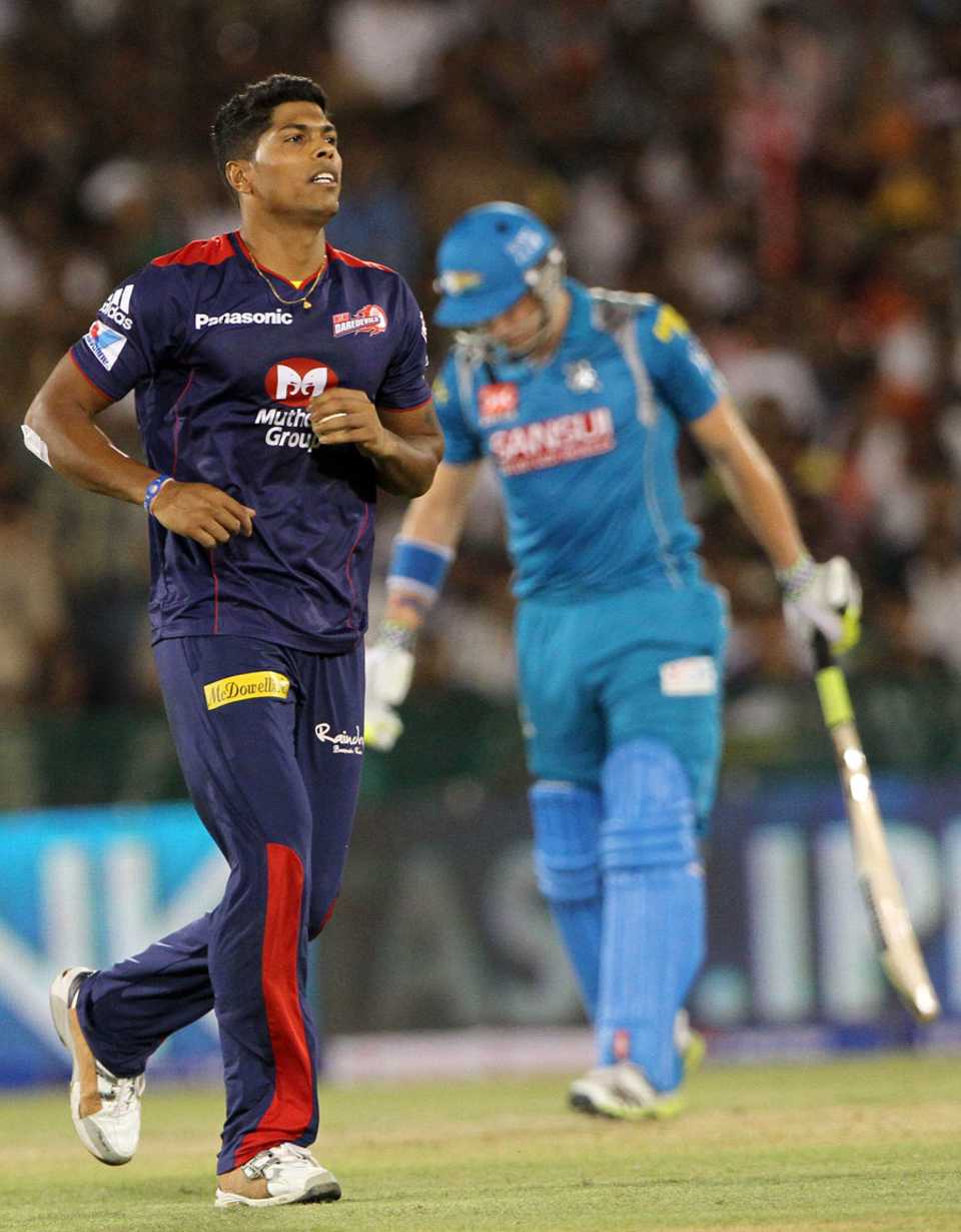 Umesh Yadav heads towards his team-mates after picking up a wicket