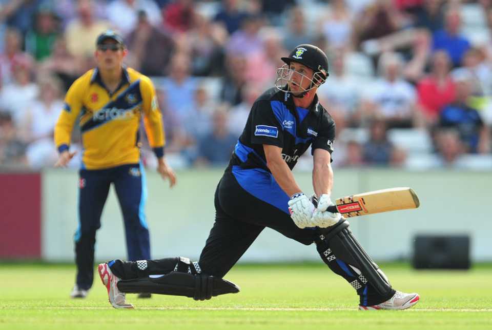 Phil Mustard sweeps during his 52-ball innings