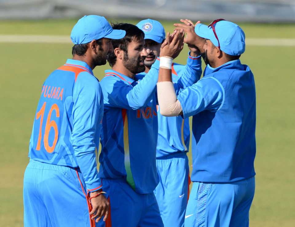 Parvez Rasool celebrates a wicket with his team-mates
