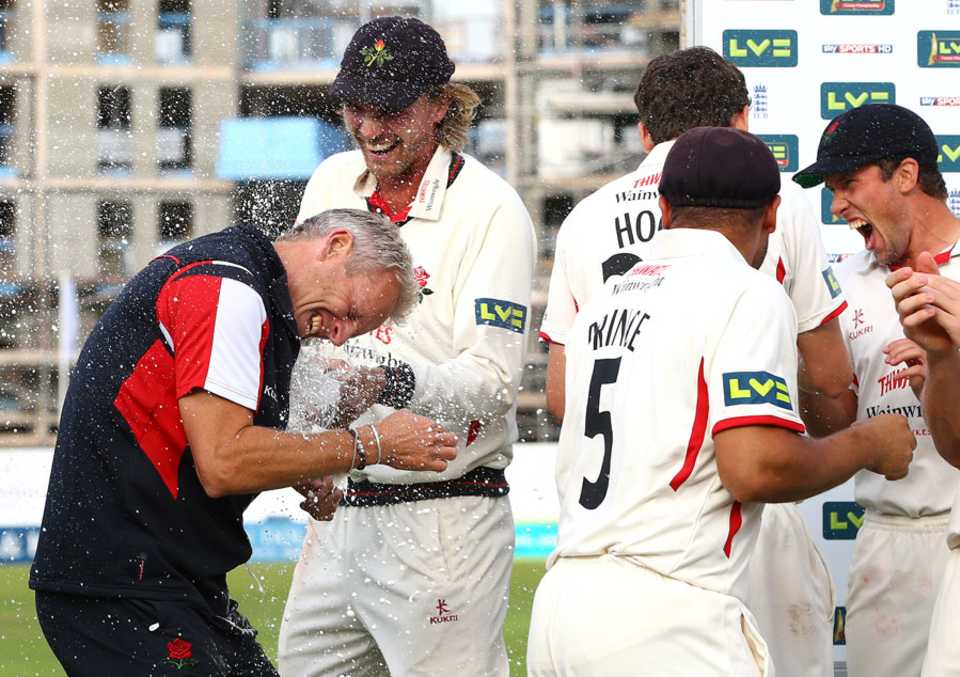 Peter Moores gets a soaking after Lancashire wrapped up the title