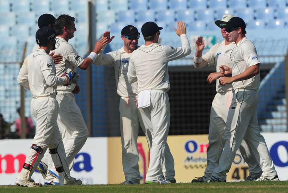 New Zealand fielders celebrate the wicket of Anamul Haque