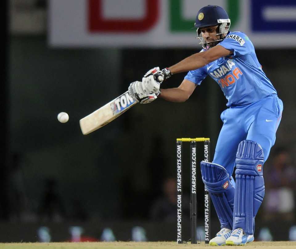 Rohit Sharma reaches out to a ball
