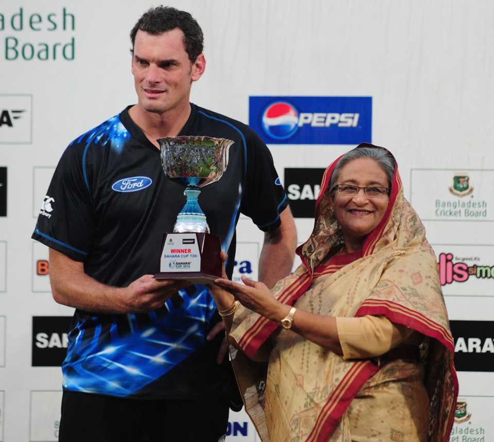 Kyle Mills receives the T20I trophy from Bangladesh Prime Minister Sheikh Hasina