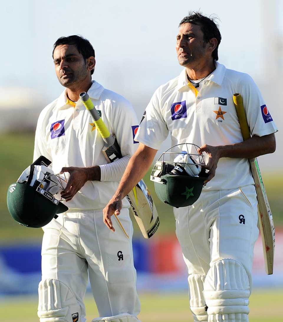 Younis Khan and Mohammad Hafeez walk off the field