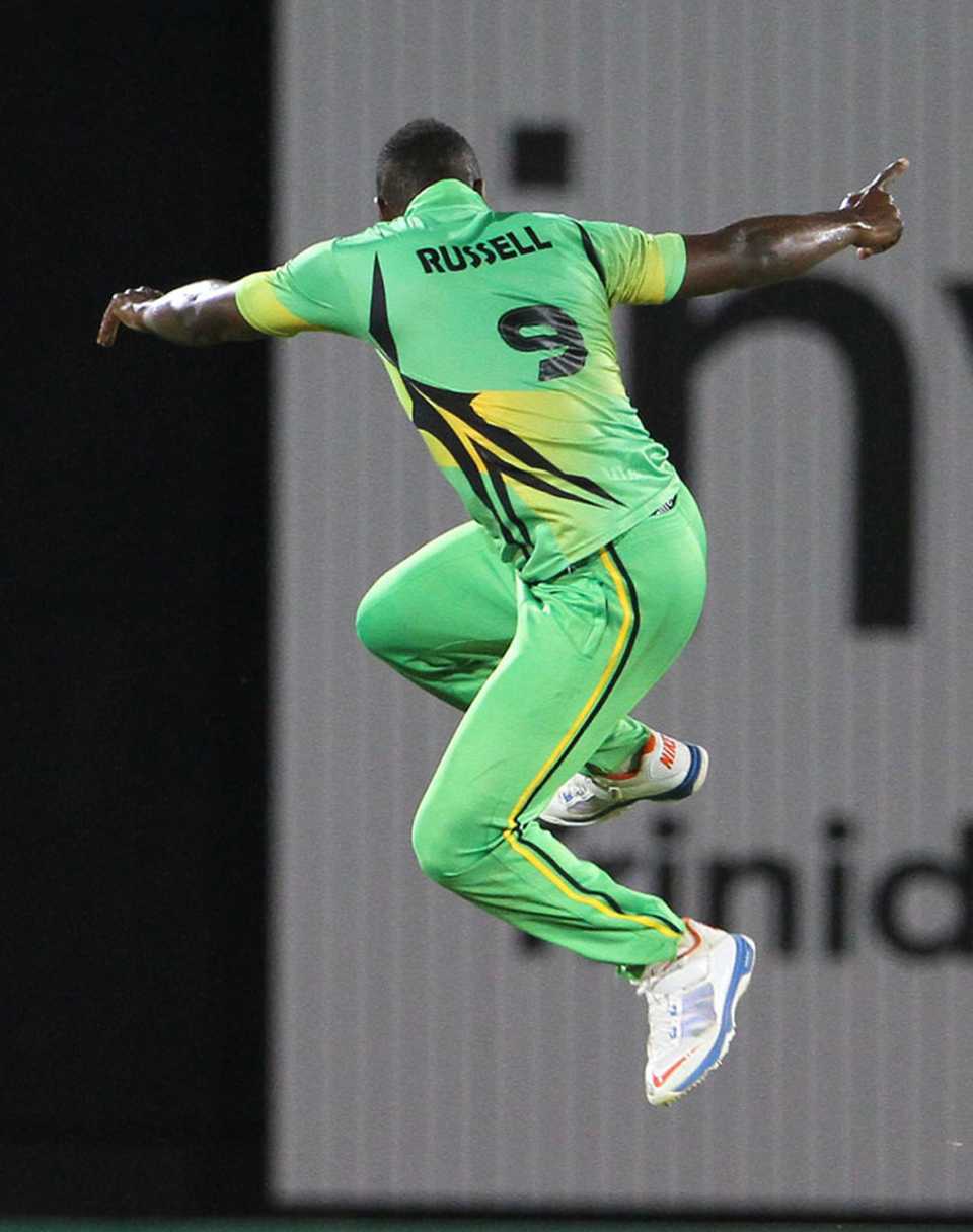 Andre Russell leaps off his feet after taking a wicket