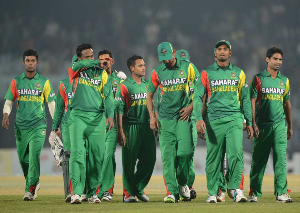 A disappointed Bangladesh team walk off after a second last-ball defeat in three days