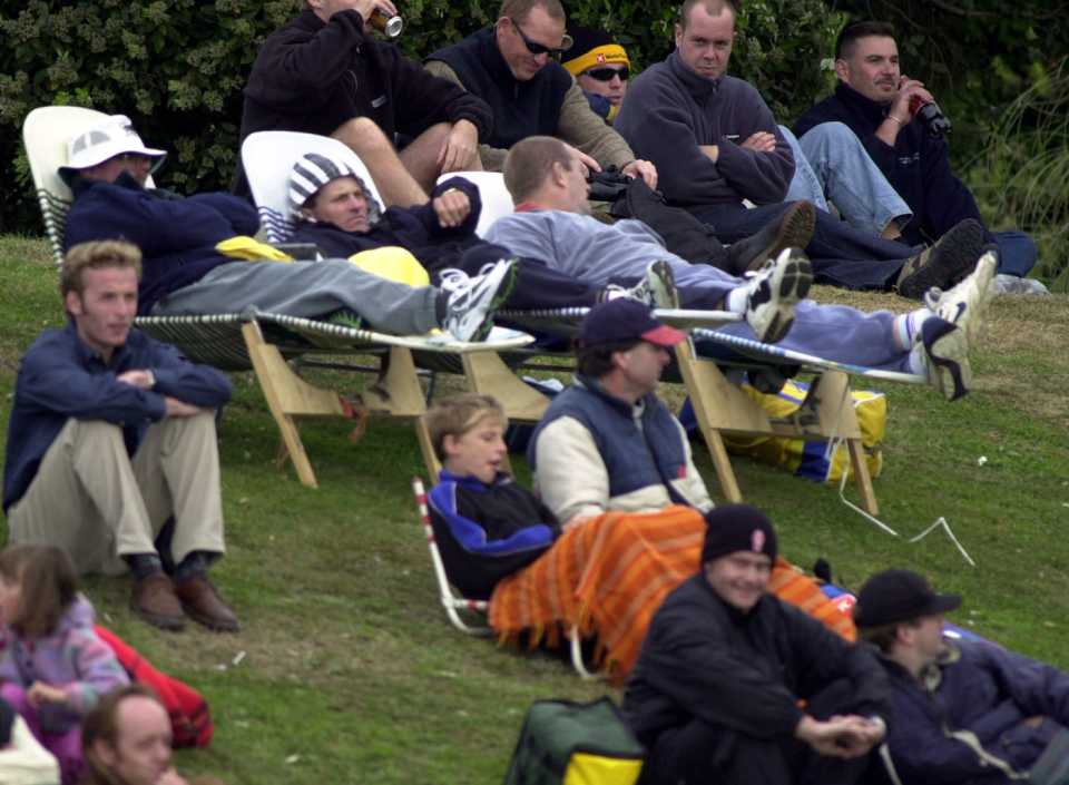 Spectators protect themselves from the freezing southerly winds, New Zealand v Australia, 2nd Test, Wellington, 2nd day, March 25, 2000