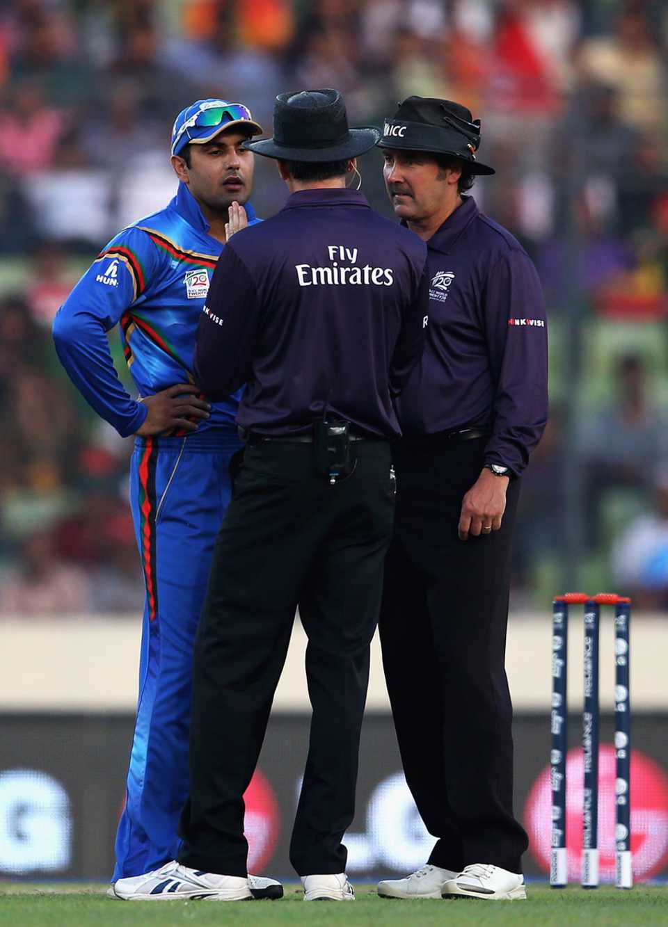 The umpires have a word with Mohammad Nabi after things got heated on the field