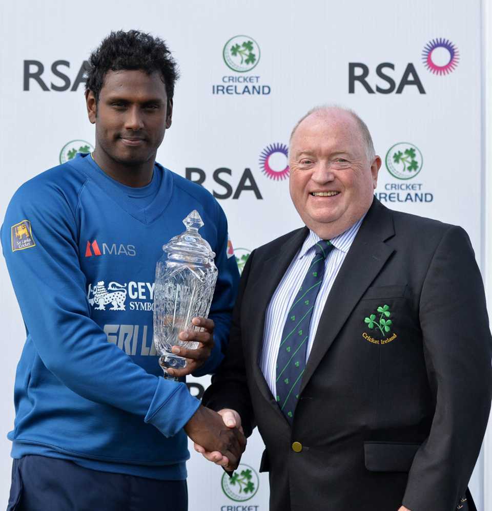 Angelo Mathews receives the series trophy