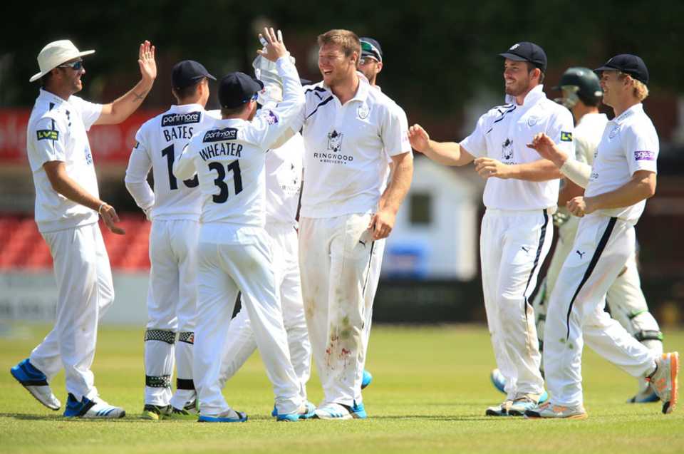 Matt Coles takes the high-fives for one of his three wickets