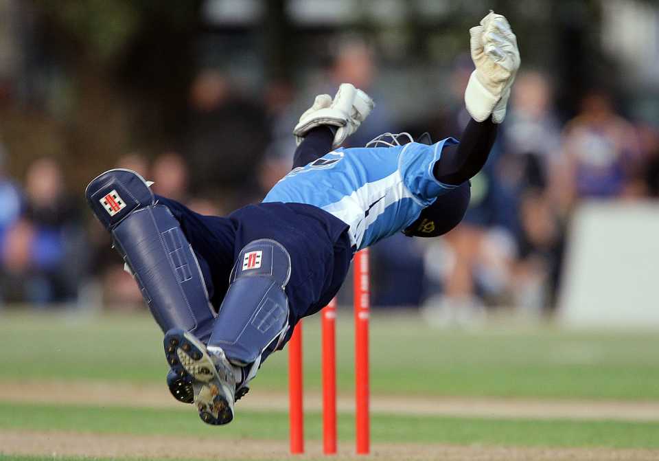 Reece Young dives backwards to take a catch to dismiss Anton Devcich