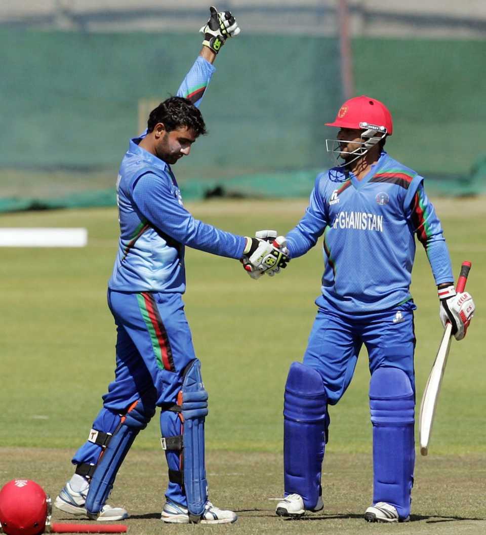 Usman Ghani is congratulated for his century by Asghar Stanikzai