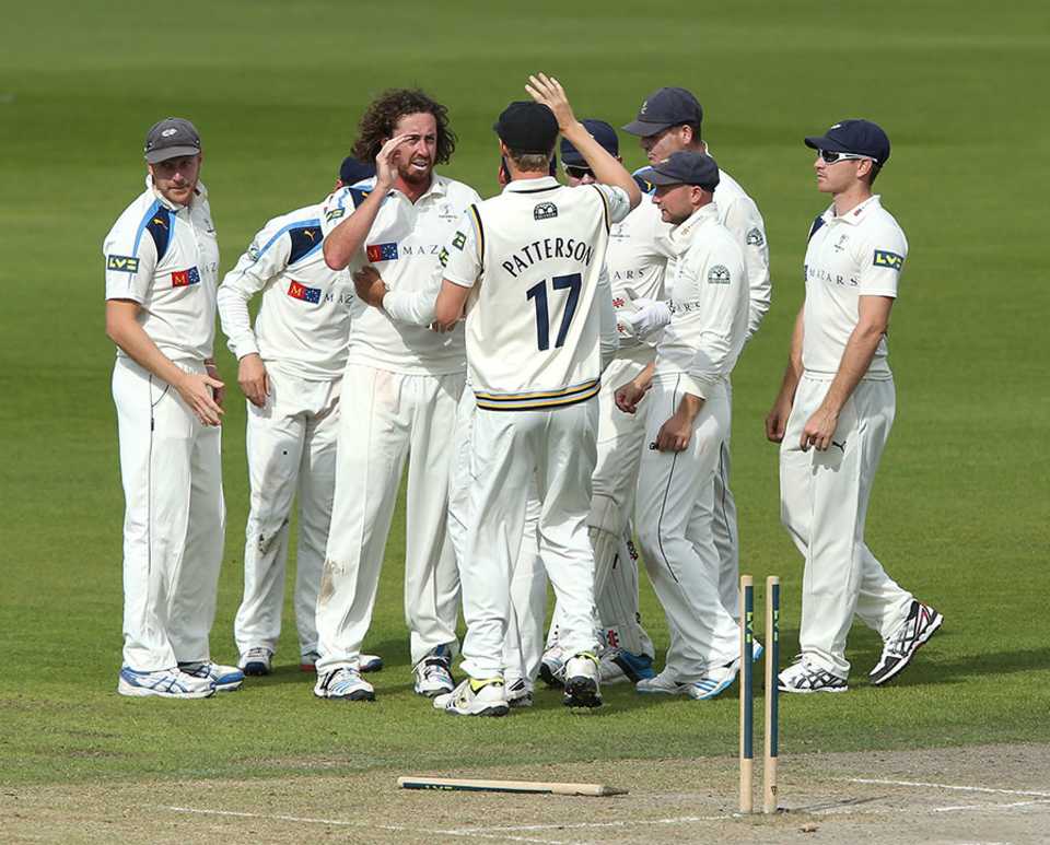 Ryan Sidebottom takes the high fives for knocking out Luis Reece's off stump