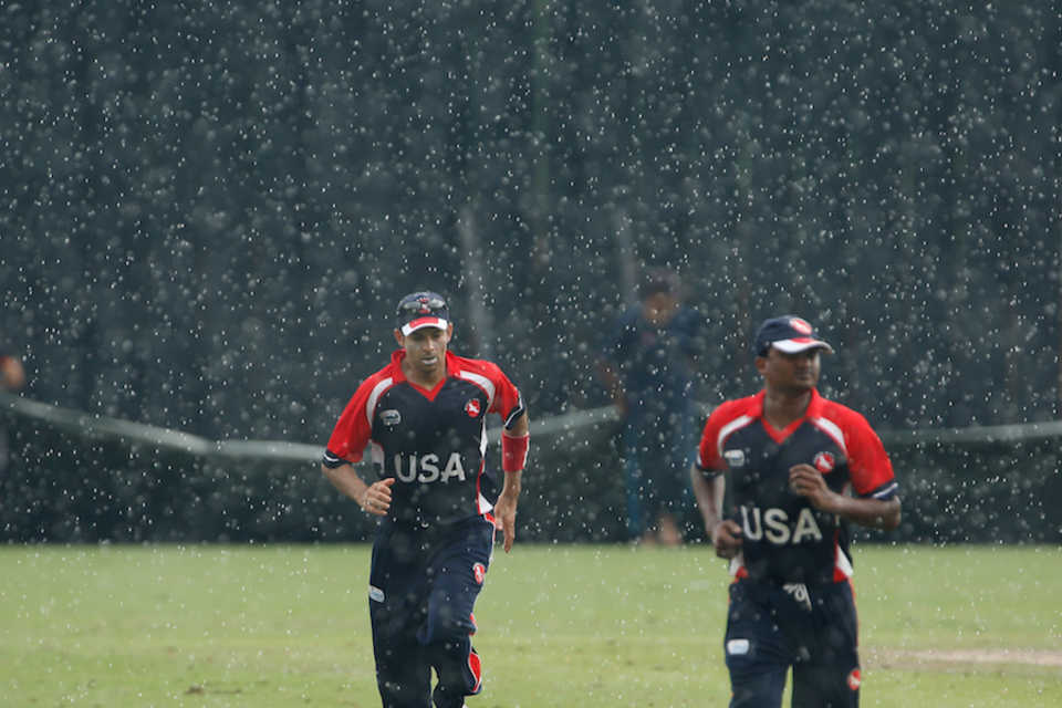 The USA players run back during a rain interruption, Nepal v USA, ICC WCL Division Three, Kuala Lumpur, October 28, 2014