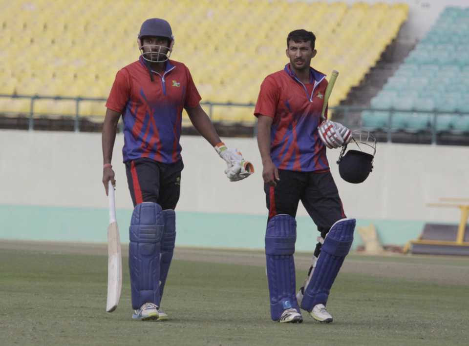 Paras Dogra and Rishi Dhawan walk off the field after Himachal Pradesh's win