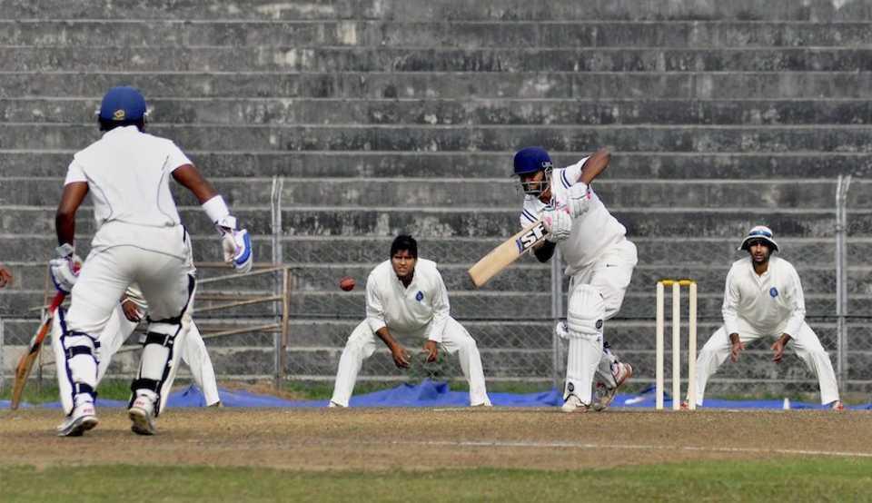 Arun Karthik pushes the ball down the ground