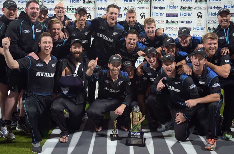 The New Zealand players celebrate with the series trophy