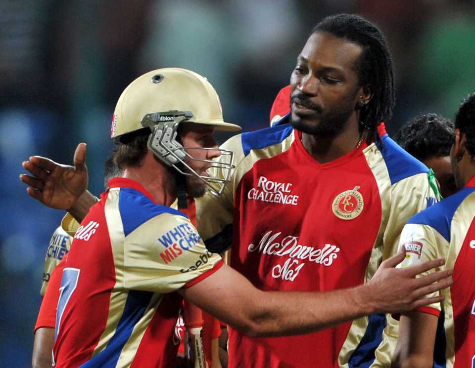 AB de Villiers is congratulated by Chris Gayle for the victory