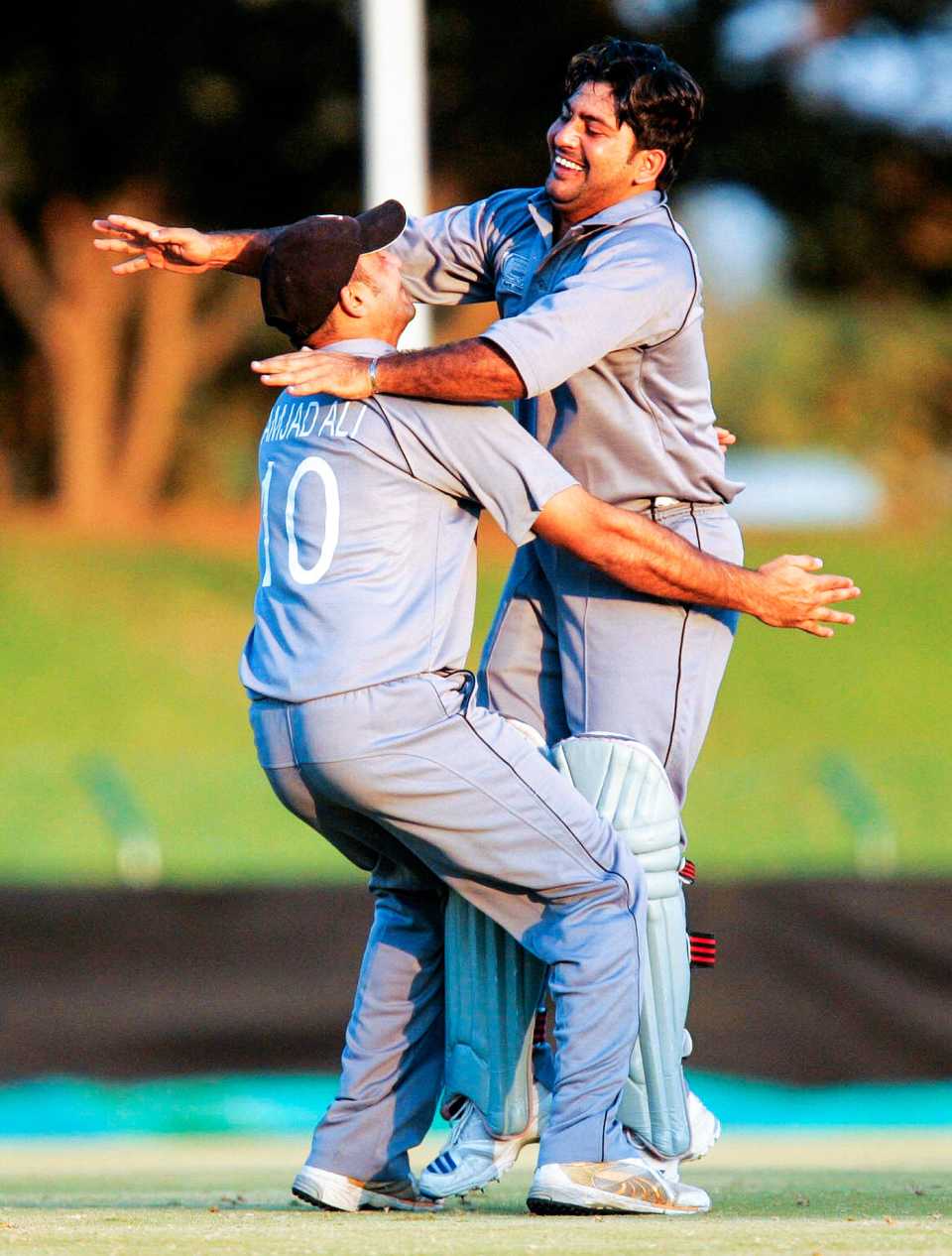 Fayyaz Ahmed is congratulated by team-mate Amjad Ali for scoring the winning runs